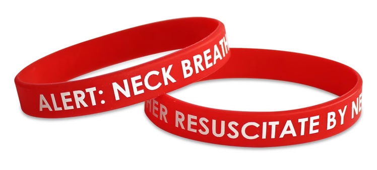 Two red silicone alert bracelets printed with the words ALERT: NECK BREATHER.